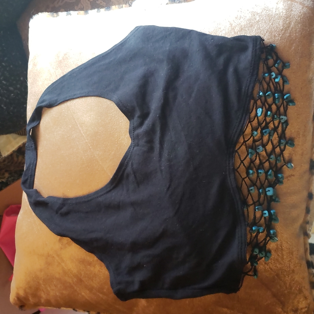 Crop top with turquoise netting below top.